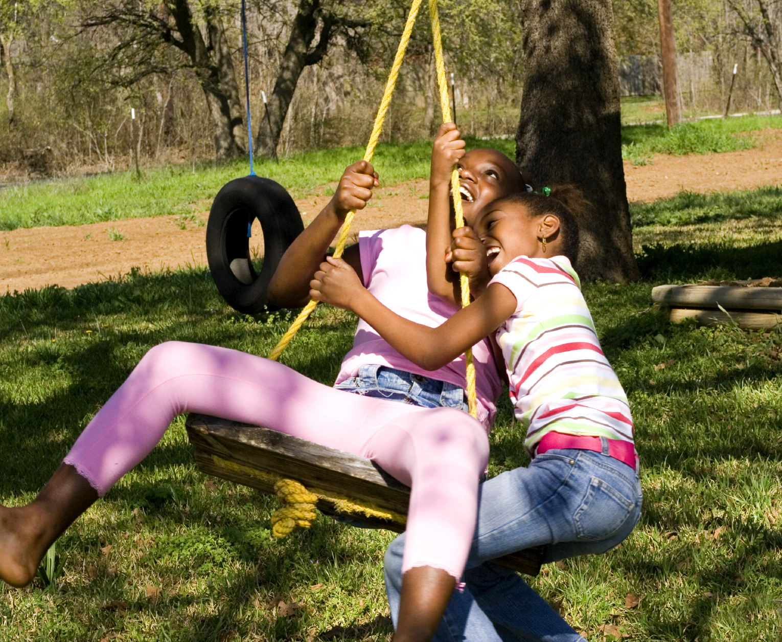 Two kids on a swing